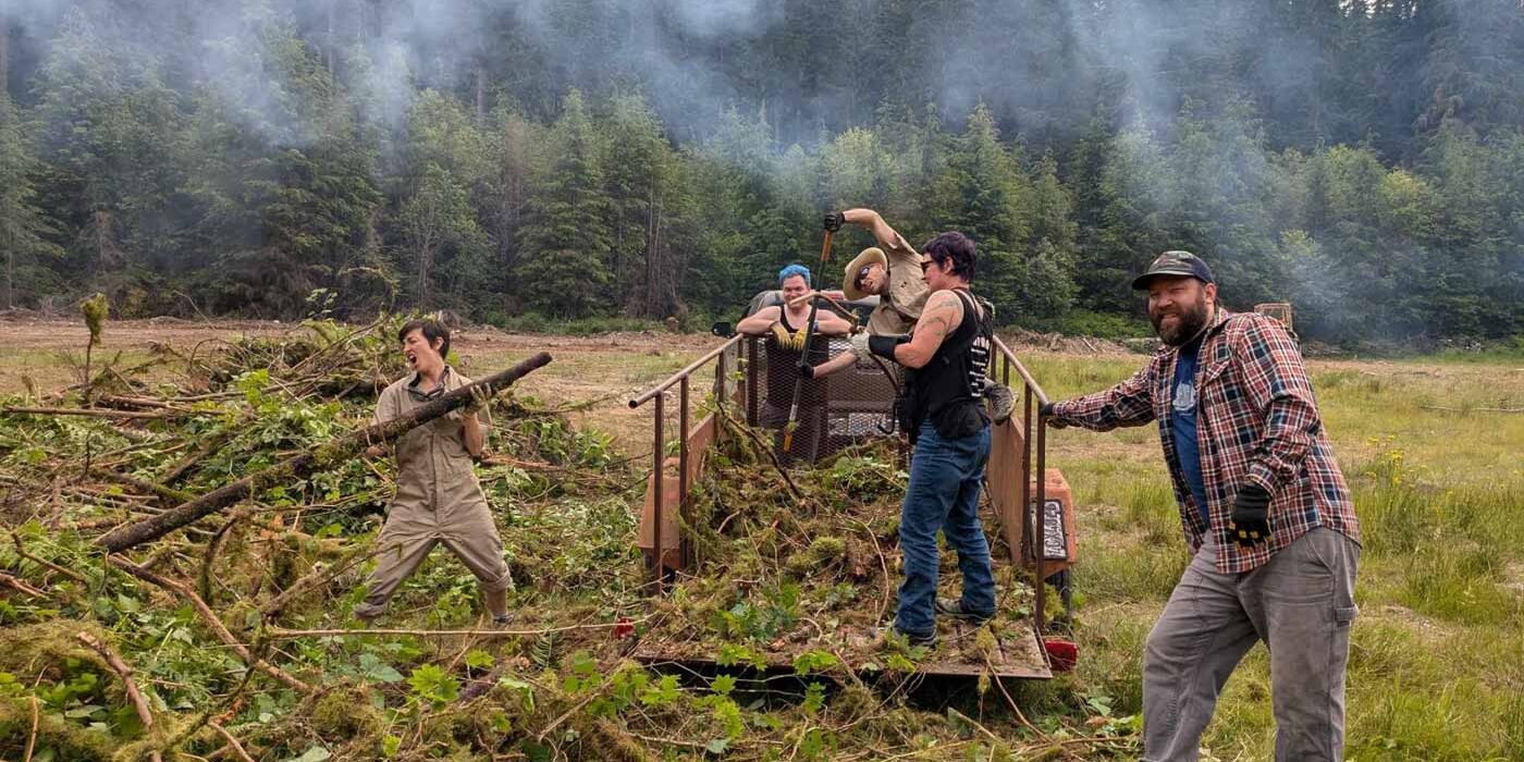 Volunteers load wood into a burn pile. Photo by Shane.